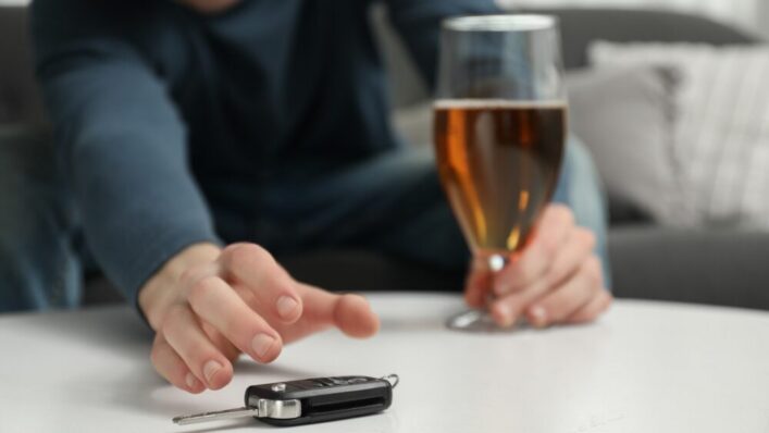 Car key beside a glass of alcohol illustrating the offence of being drunk in charge of a vehicle